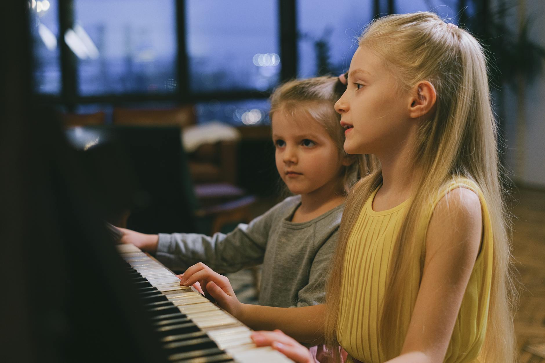 photo of girls playing piano